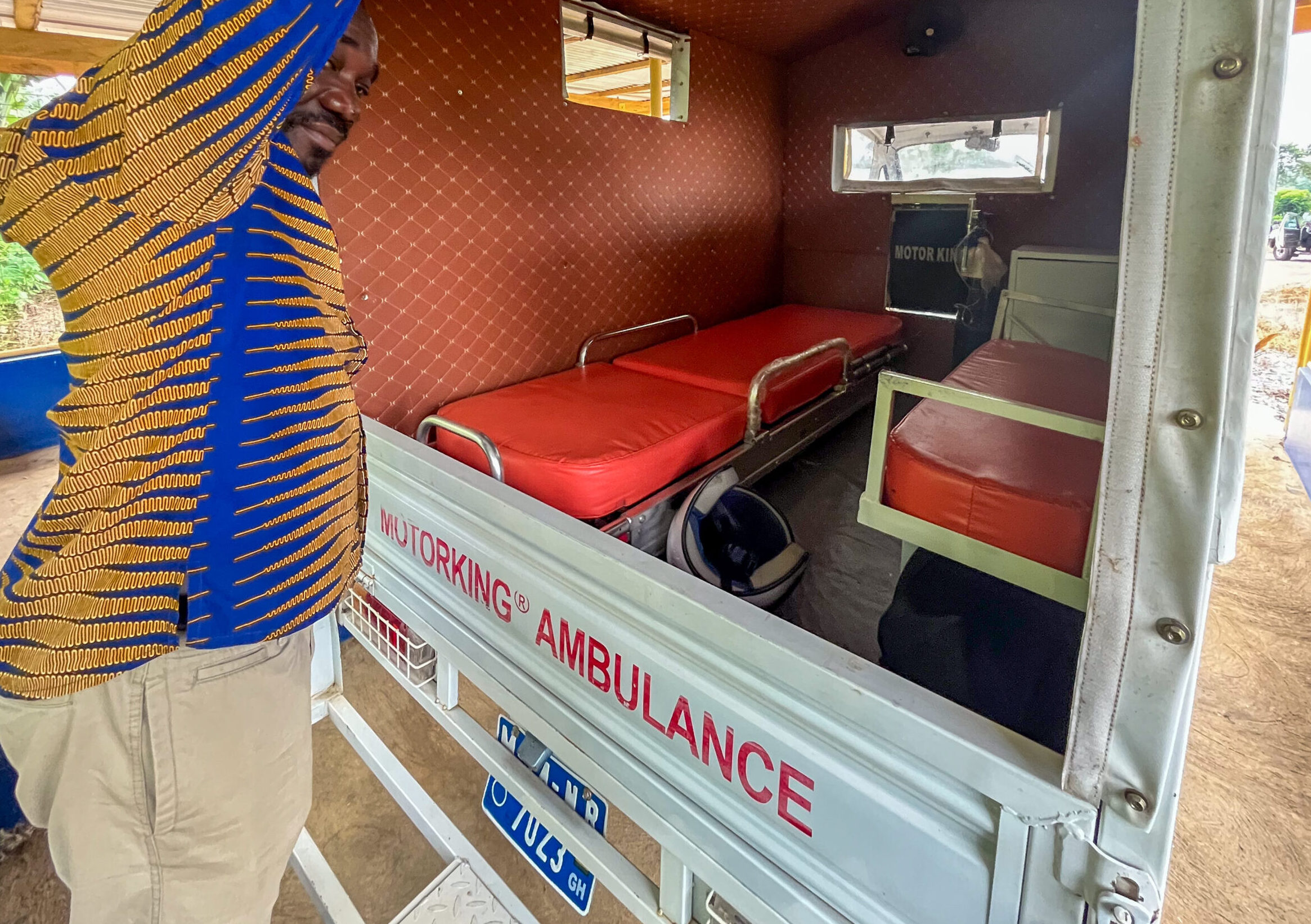 The interior of a motor ambulance in Ghana with a patient stretcher and seating for medical transport.
